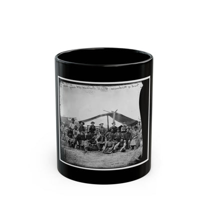 Black-and-white albumen view of about sixteen workmen in aprons and slouch hats posed before a canvas tent.