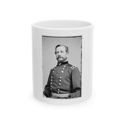 Black and white portrait of a bearded man in a double-breasted military coat with a braided sash belt.