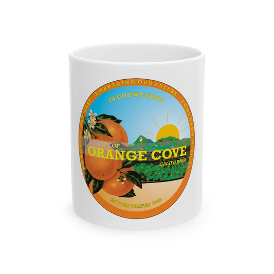 Round badge for Orange Cove, California, with oranges on a branch, a rising sun over green hills and an orchard.