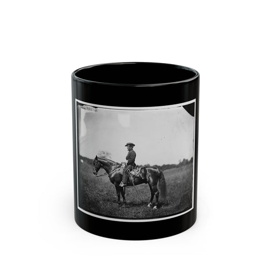 Black and white print of a mounted soldier in a kepi beside a dark bay horse in an open grassy field.