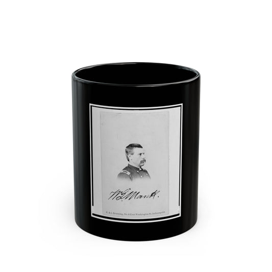 Black-and-white studio portrait of a man in profile wearing a military-style uniform, with a handwritten signature.