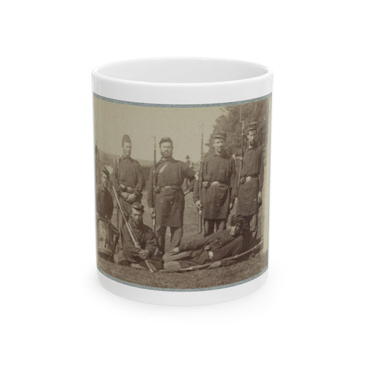 Sepia print showing 19th-century infantrymen with muskets and a snare drum posed outdoors on grass.