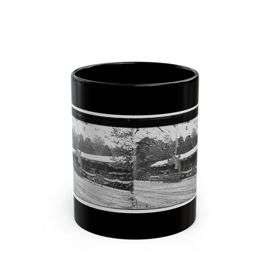 Black and white stereo view of a long bunting-draped reviewing stand with flags, set beside a line of trees.