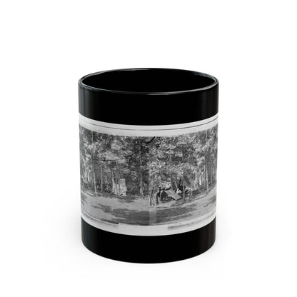 Black and white stereograph of a wooded army camp with canvas tents and soldiers resting.