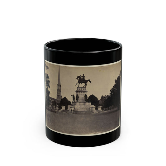 Sepia view of an equestrian statue of Washington on a stone pedestal, with a church steeple behind.