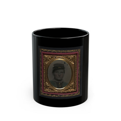 Tintype of a young man in a dark forage cap, shown head and shoulders inside a gilt oval frame with pink velvet.