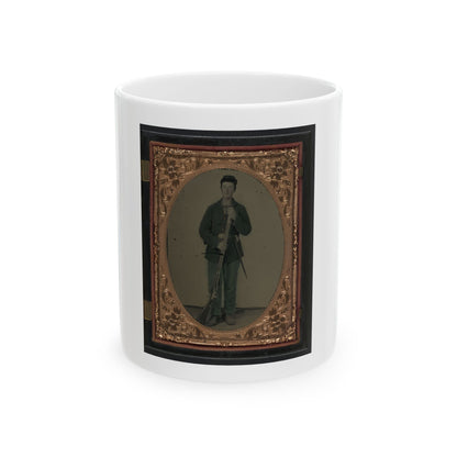 Hand-tinted tintype of a standing soldier in a kepi holding a musket, framed in an embossed copper-gold oval mat.