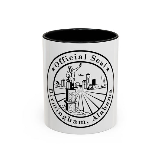 Black and white circular seal with a statue holding a torch above a city skyline and radiating rays.