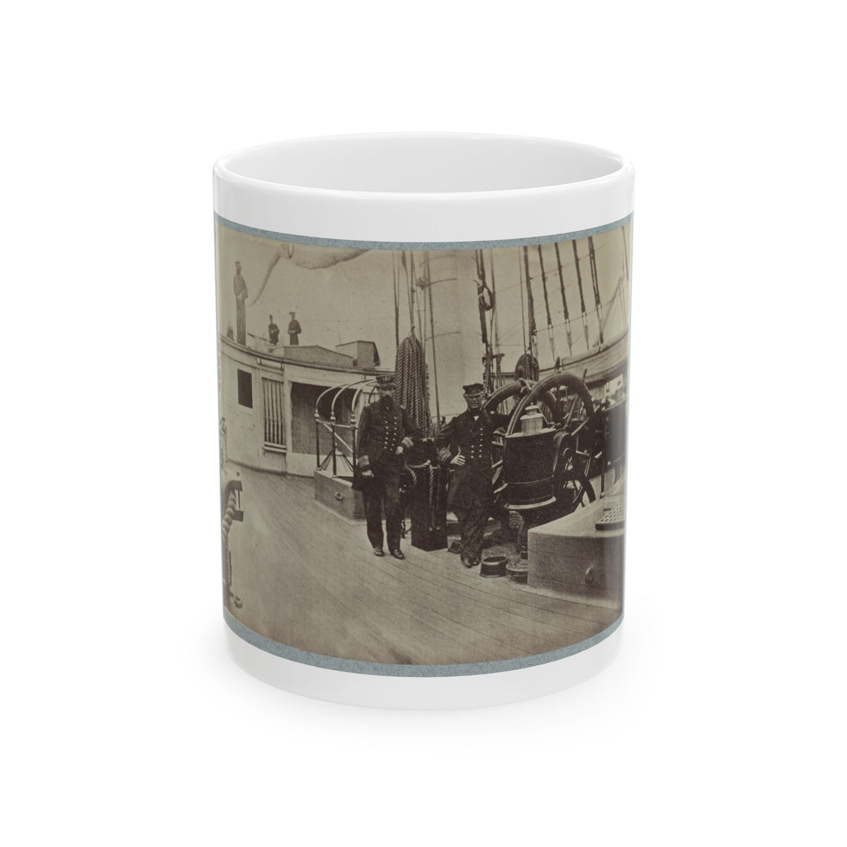 Sepia view of two officers in dark uniforms beside a steering wheel on a wooden ship deck, with coiled rope.