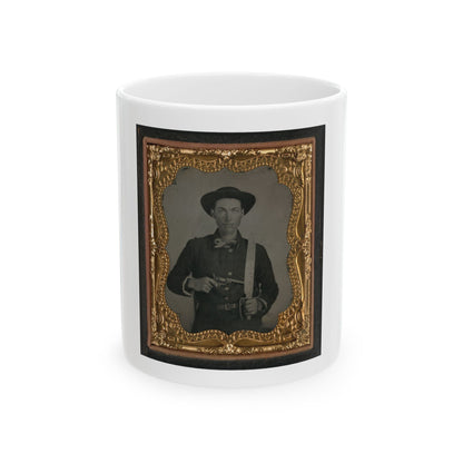 Sepia tintype of a man in a wide-brimmed hat holding a revolver and a sword, set in an ornate gilt frame.
