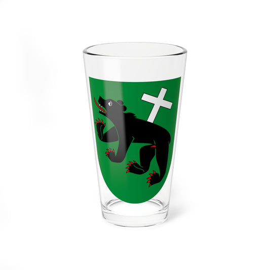 Black bear with red claws and tongue walking across a green heraldic shield beneath a white cross.