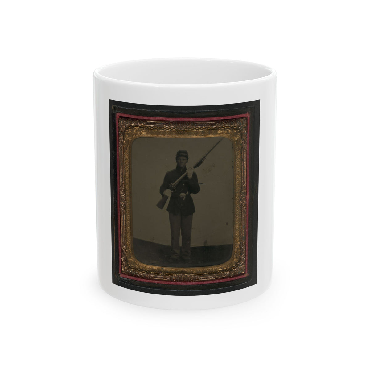 Antique tintype of a standing soldier in a kepi shouldering a rifle, set in an ornate gold scrolled frame.