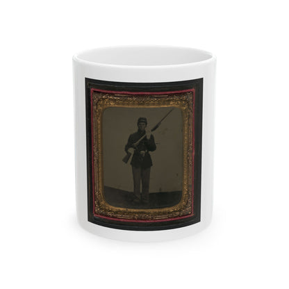 Antique tintype of a standing soldier in a kepi shouldering a rifle, set in an ornate gold scrolled frame.