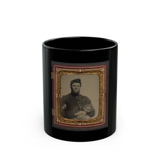 Sepia portrait of a bearded young soldier resting his hands on a kepi with an eagle badge, in an ornate gilt case.