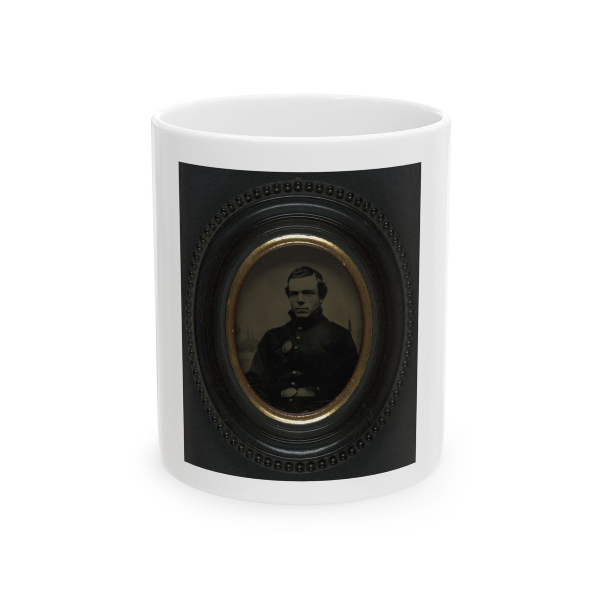 Sepia tintype portrait of a man in a dark coat inside a black oval beaded frame with a gilt inner mat.