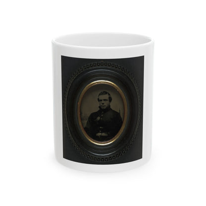 Sepia tintype portrait of a man in a dark coat inside a black oval beaded frame with a gilt inner mat.