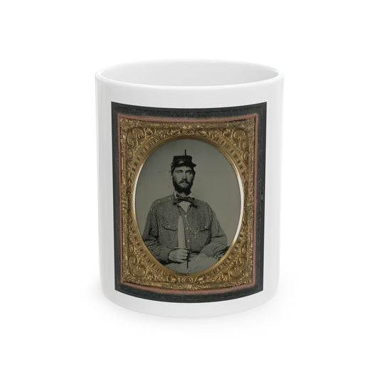 Oval tintype of a bearded man in a checked shirt and forage cap holding an upright knife, in an ornate gilt case.