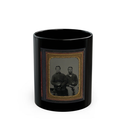 Two seated men in dark jackets holding kepi caps, in a vintage tintype portrait framed in gold diamond-pattern metal.