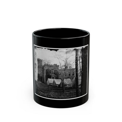 Black and white 19th-century view of a stone castle-like building with canvas tents and bare trees in front.