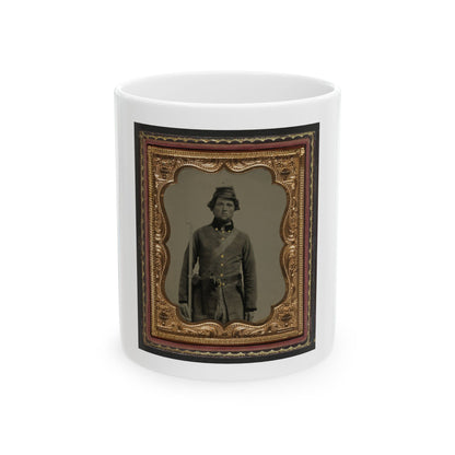 Sepia tintype of a standing soldier in a kepi with a rifle, set in an embossed gold scalloped frame inside a case.