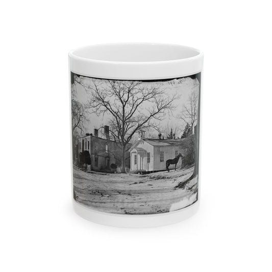 Black and white historical view of a small white clapboard chapel with a bell cupola, a horse and wagon in snow.