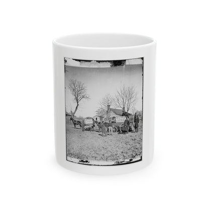 Black and white 1860s view of a horse-drawn wagon, a view camera on a tripod, and men in an open dirt yard.