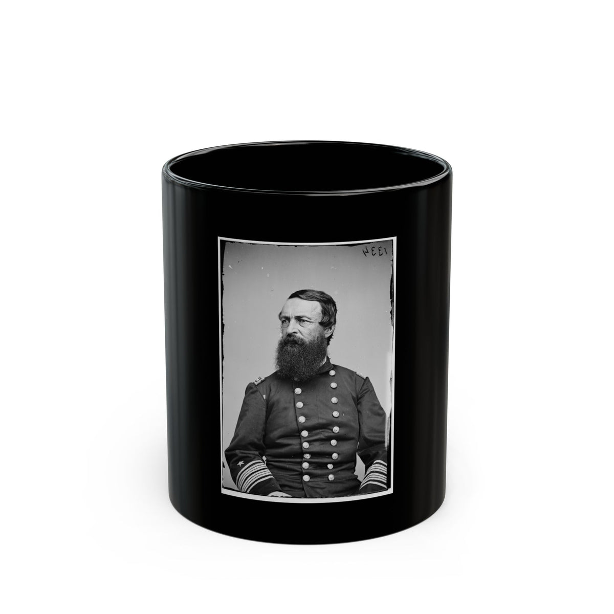 Black and white studio portrait of a bearded man in a dark double-breasted uniform with striped sleeve cuffs.