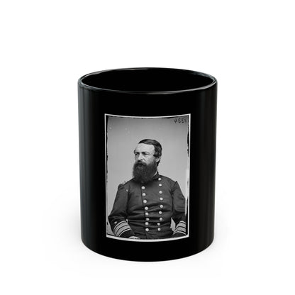 Black and white studio portrait of a bearded man in a dark double-breasted uniform with striped sleeve cuffs.