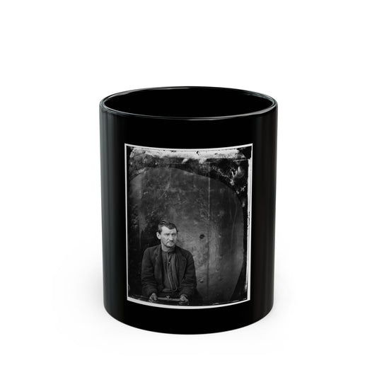 Black and white 1860s studio portrait of a seated man in a dark buttoned jacket against a mottled arched backdrop.