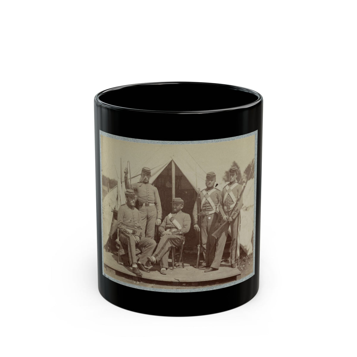 Sepia print showing five uniformed soldiers with rifles posed before a canvas tent on a wooden platform.