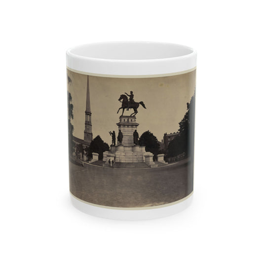 Sepia view of an equestrian statue of Washington on a stone pedestal, with a church steeple behind.