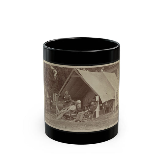 Sepia scene of uniformed officers seated and standing beside a canvas tent in an outdoor encampment.