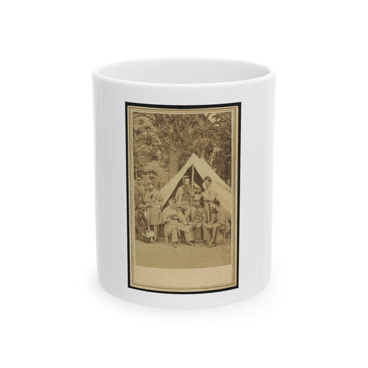 Sepia print of about eight uniformed soldiers posed around a canvas tent under a large tree.