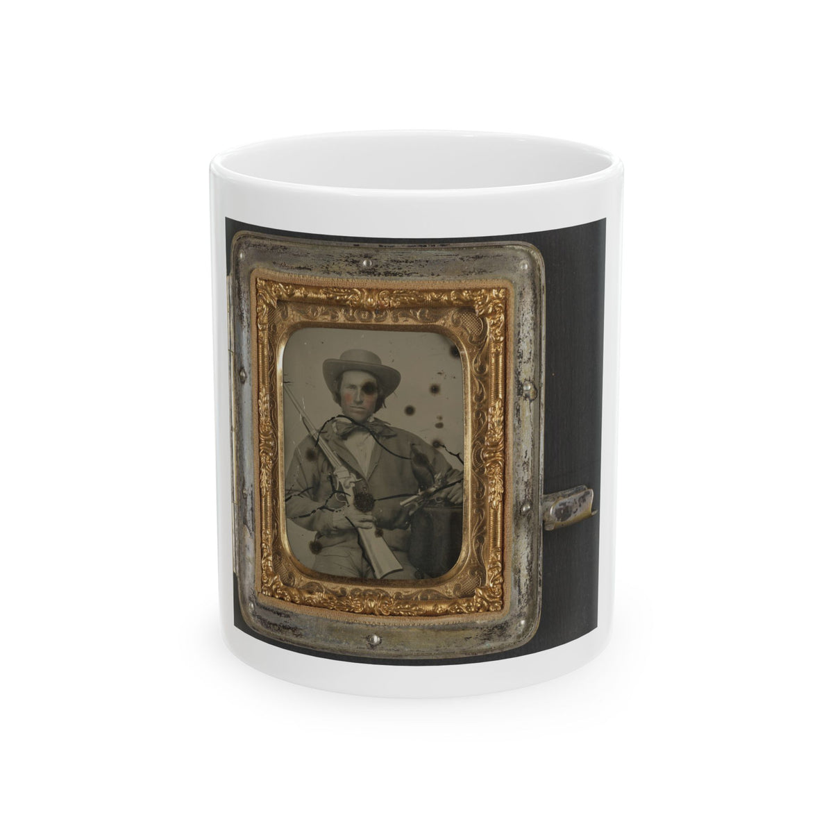 Sepia tintype of a man in a wide-brimmed hat holding a rifle across his chest, set in an ornate gold frame.