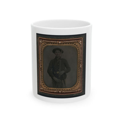 Antique tintype of a soldier in a dark uniform and forage cap holding a rifle with bayonet, in a gold star-point frame.