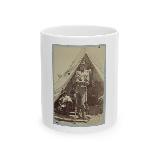 Sepia print showing a soldier with a rifle at a canvas tent entrance, with a seated musician resting inside.