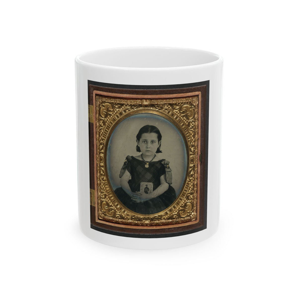Sepia tintype of a young girl in a dark plaid dress holding a small portrait, inside an oval gilt case.
