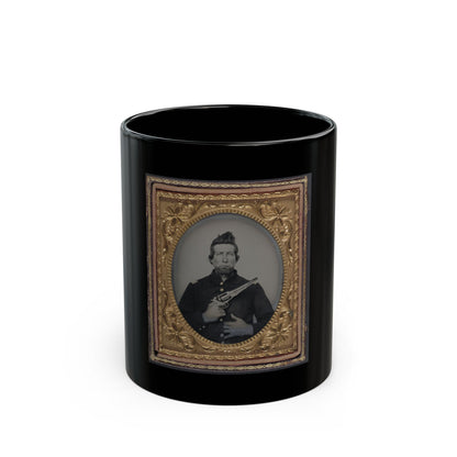Sepia tintype of a man in a dark coat holding a revolver, set inside an ornate gilt frame.
