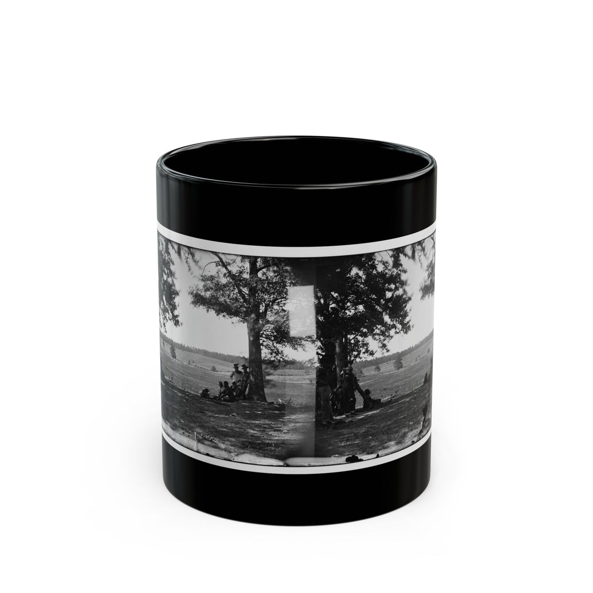 Black and white stereograph of soldiers resting under large trees in an open grassy field, seen as a paired view.