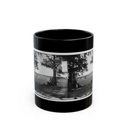 Black and white stereograph of soldiers resting under large trees in an open grassy field, seen as a paired view.