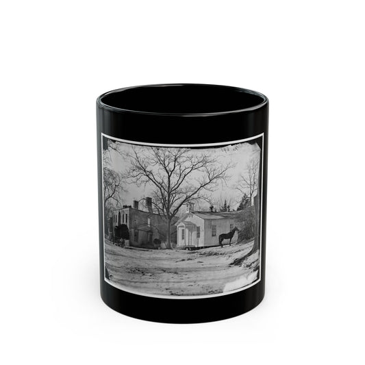 Black and white historical view of a small white clapboard chapel with a bell cupola, a horse and wagon in snow.