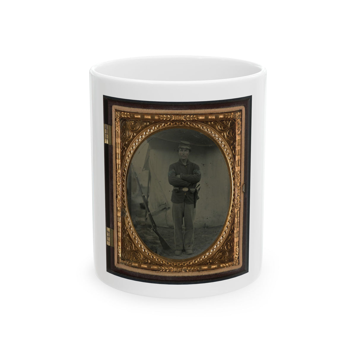 Sepia tintype of a Civil War soldier with arms crossed beside a rifle leaning against a canvas tent.