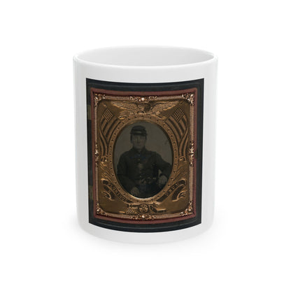 Antique tintype of a seated Union soldier in an ornate gilt frame decorated with an eagle, flags and a cannon.