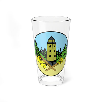 Round olive-green badge showing an observation tower among pine trees, with two crossed yellow brooms in front.