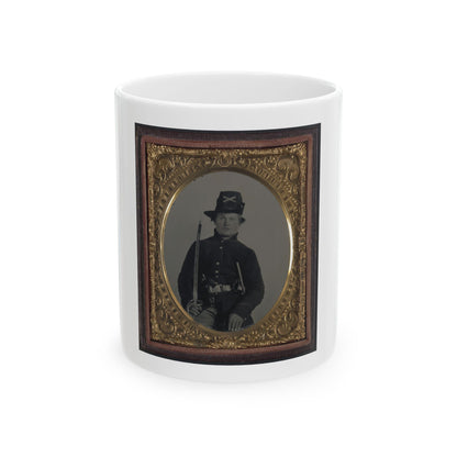 Monochrome tintype of a Civil War soldier with a sabre and crossed-sabre hat badge, set in an ornate gilt frame.