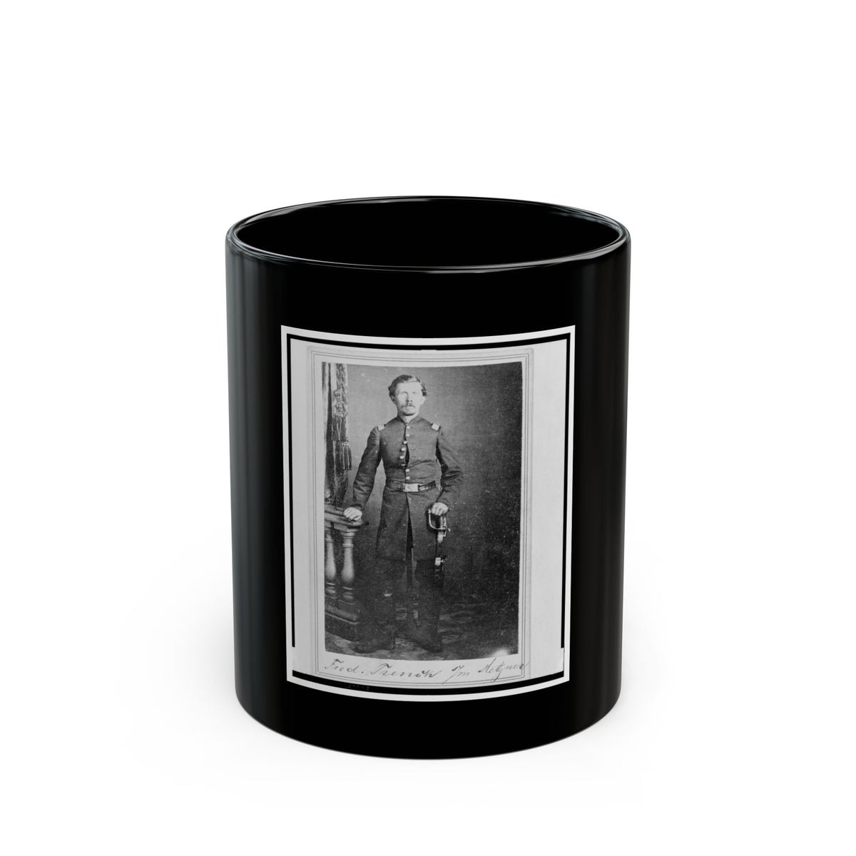 Black and white studio portrait of a standing officer in uniform holding a sword beside a carved pedestal.