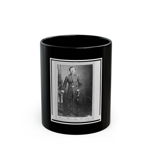 Black and white studio portrait of a standing officer in uniform holding a sword beside a carved pedestal.