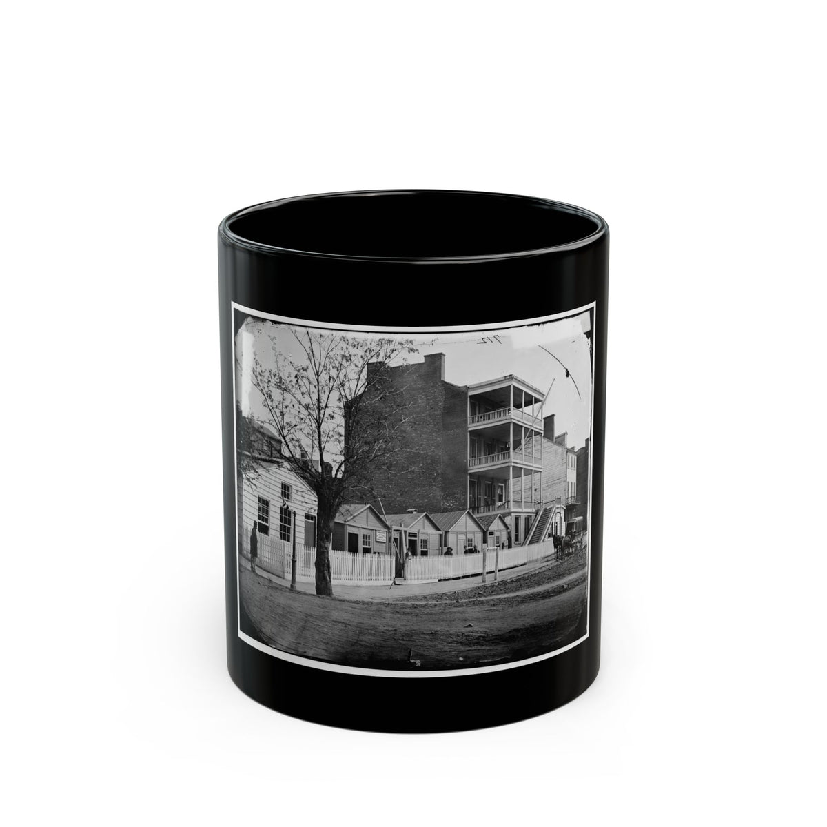 Black and white 1860s view of a multi-storey brick building with wooden balconies and a horse-drawn carriage.