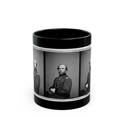 Black and white vintage triptych of one seated bearded man in a dark military coat, repeated in three panels.