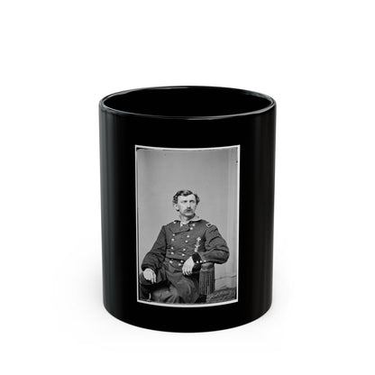 Black and white 19th-century studio portrait of a seated, moustached officer in a military coat with brass buttons.